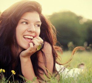 Brunette Girl Lying In Field