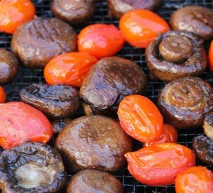Grilled mushrooms and tomatoes on whole grain bagel